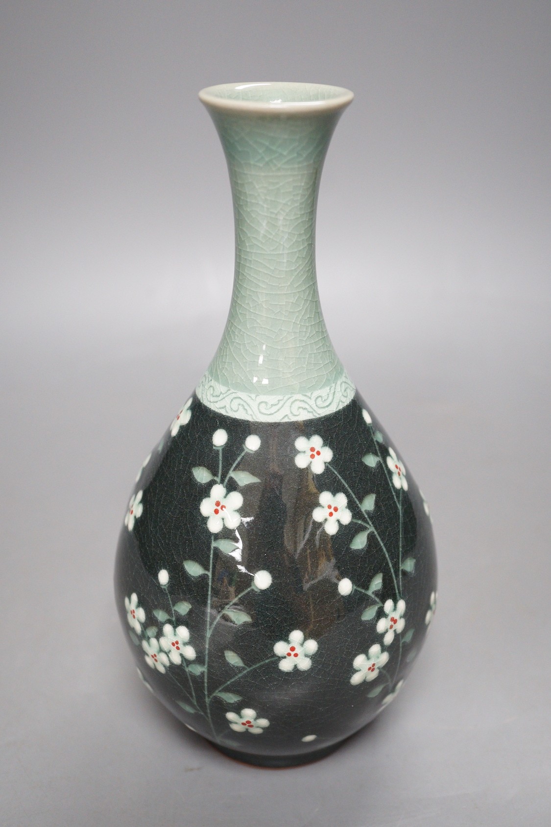 A Korean celadon ground floral decorated bottle vase, 20.5cm